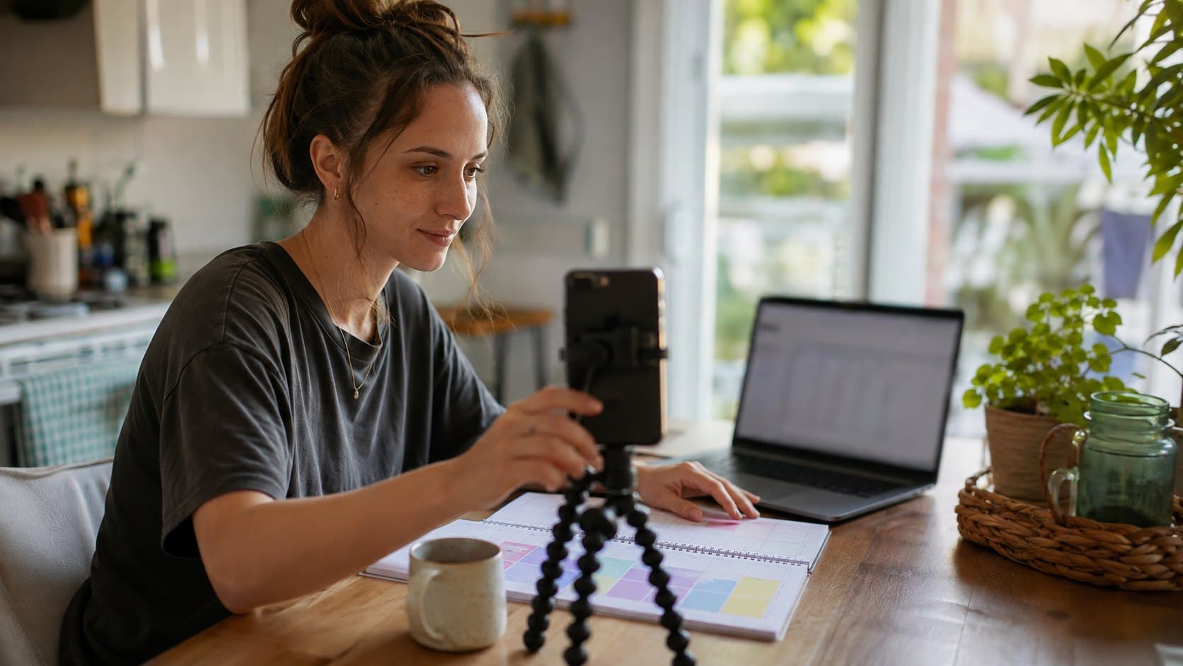 Creator preparing a TikTok post at a kitchen table during a practical backup posting window